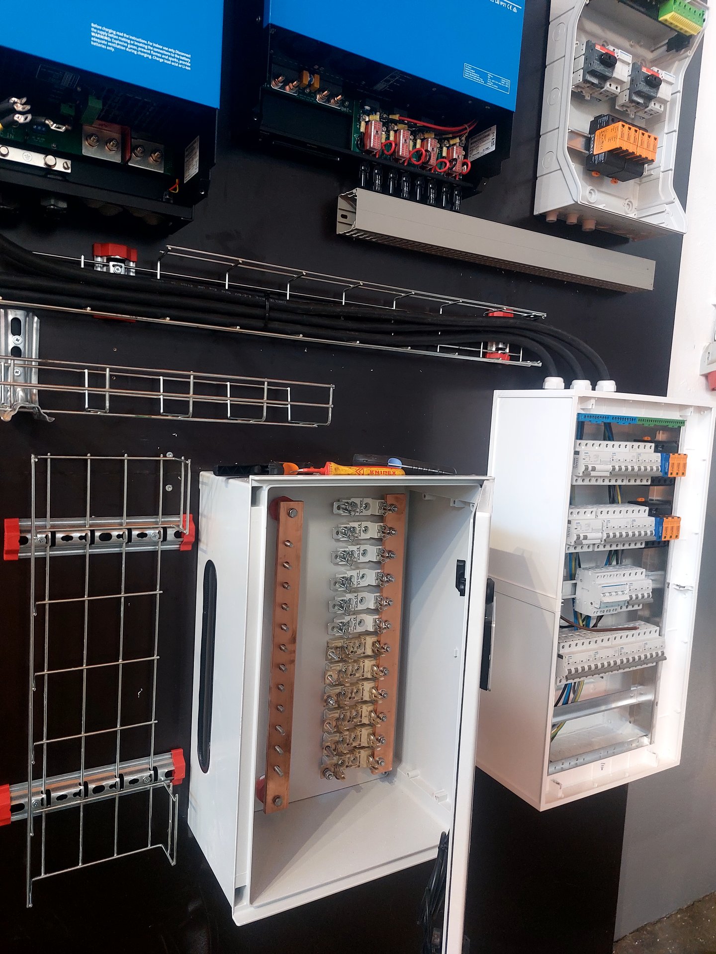 Copper busbars and breaker panels set out neatly