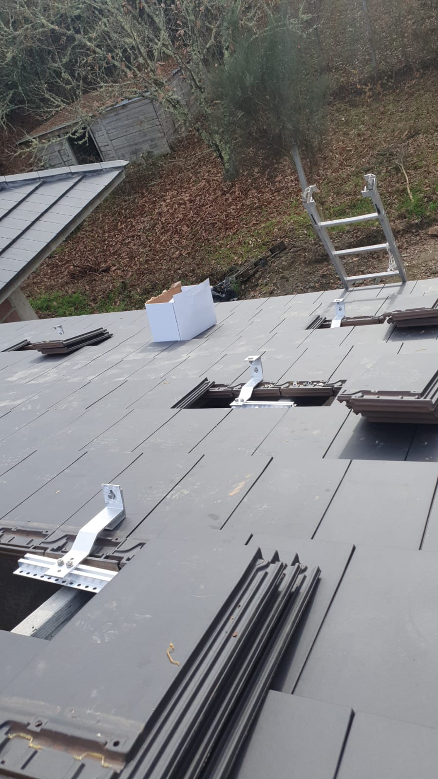 Roof tiles lifted and rails set out before the panels go on